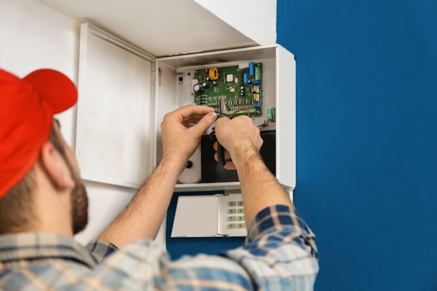 Young Electrician Installing Alarm System